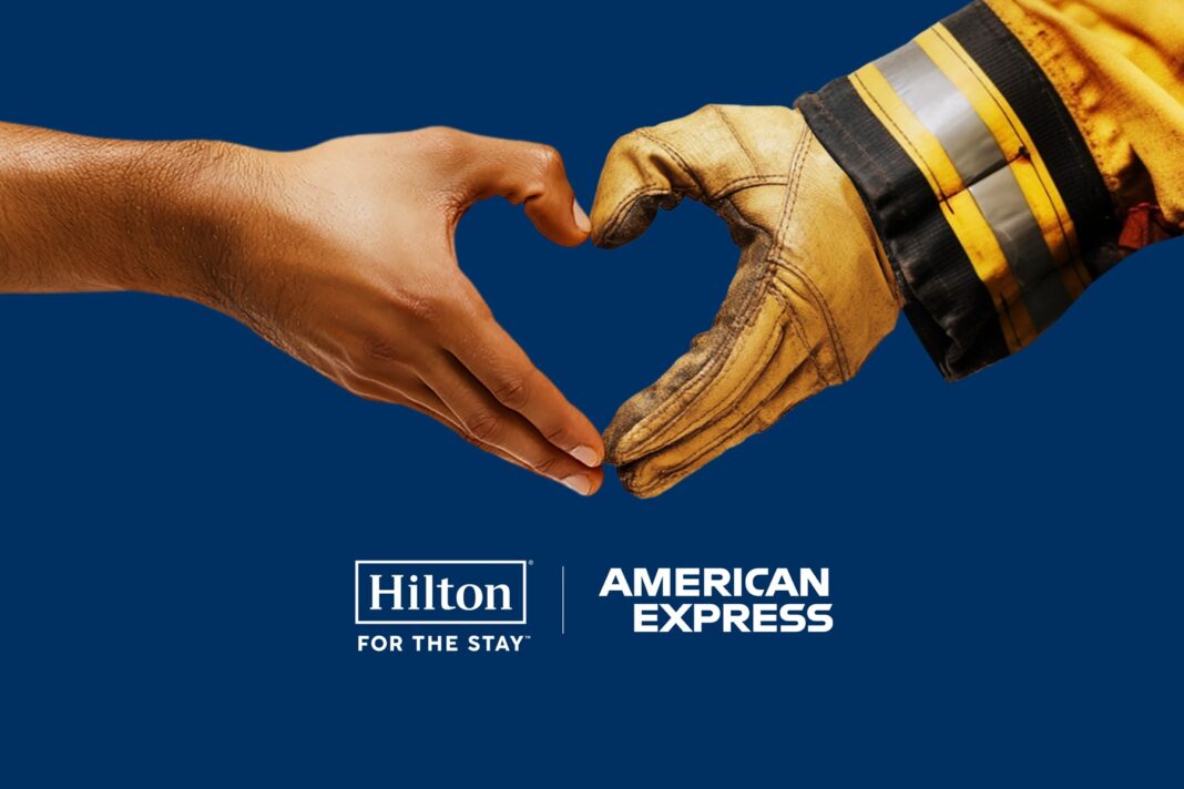 Hilton and American Express to Provide Hotel Rooms to Support Los Angeles Wildfire Relief, a person's hand and a firefighter's hand coming together to make a heart symbol, Hilton For the Stay Logo and American Express Logo, blue background