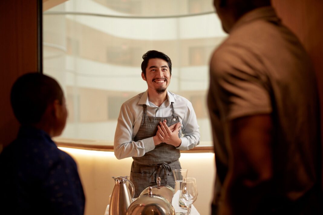 Hilton Food & Beverage Team Member with Guests